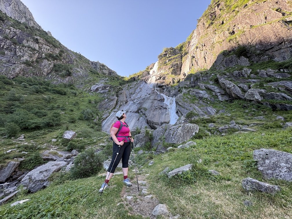 woman in hiking gear posing with hiking poles at Mont Valier in France