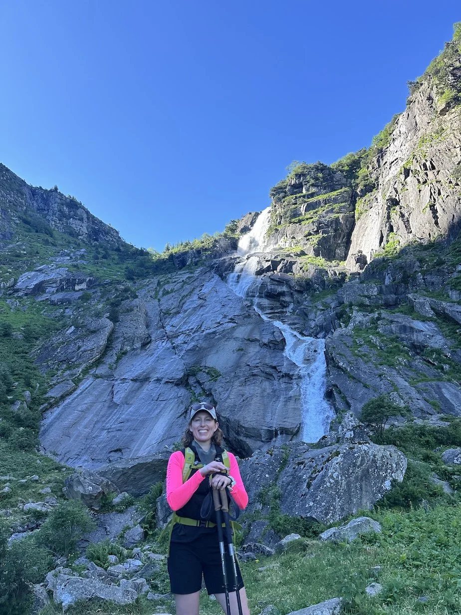 woman in hiking gear on the foothills of mont valier in france walking the chemin de la liberté