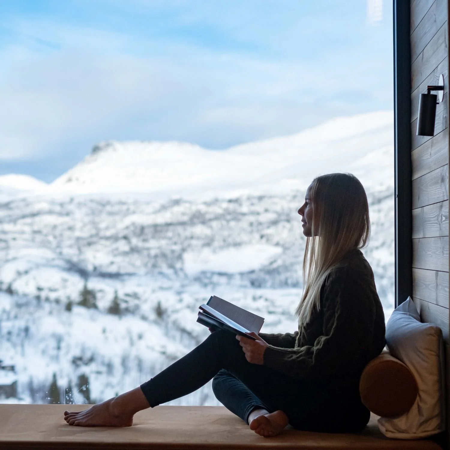 Woman journaling at a health and wellness retreat in the scandinavian alps
