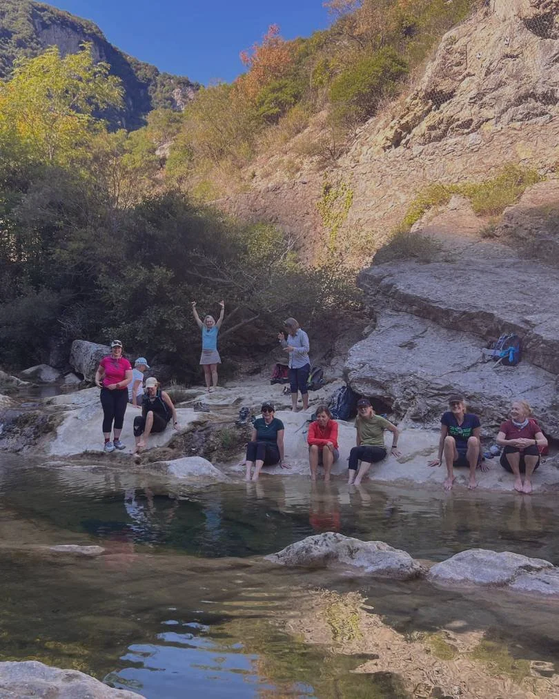 group of women in midlife on a retreat in southern France taking a swim in Gorges de Galamus guided by Athara Adventures