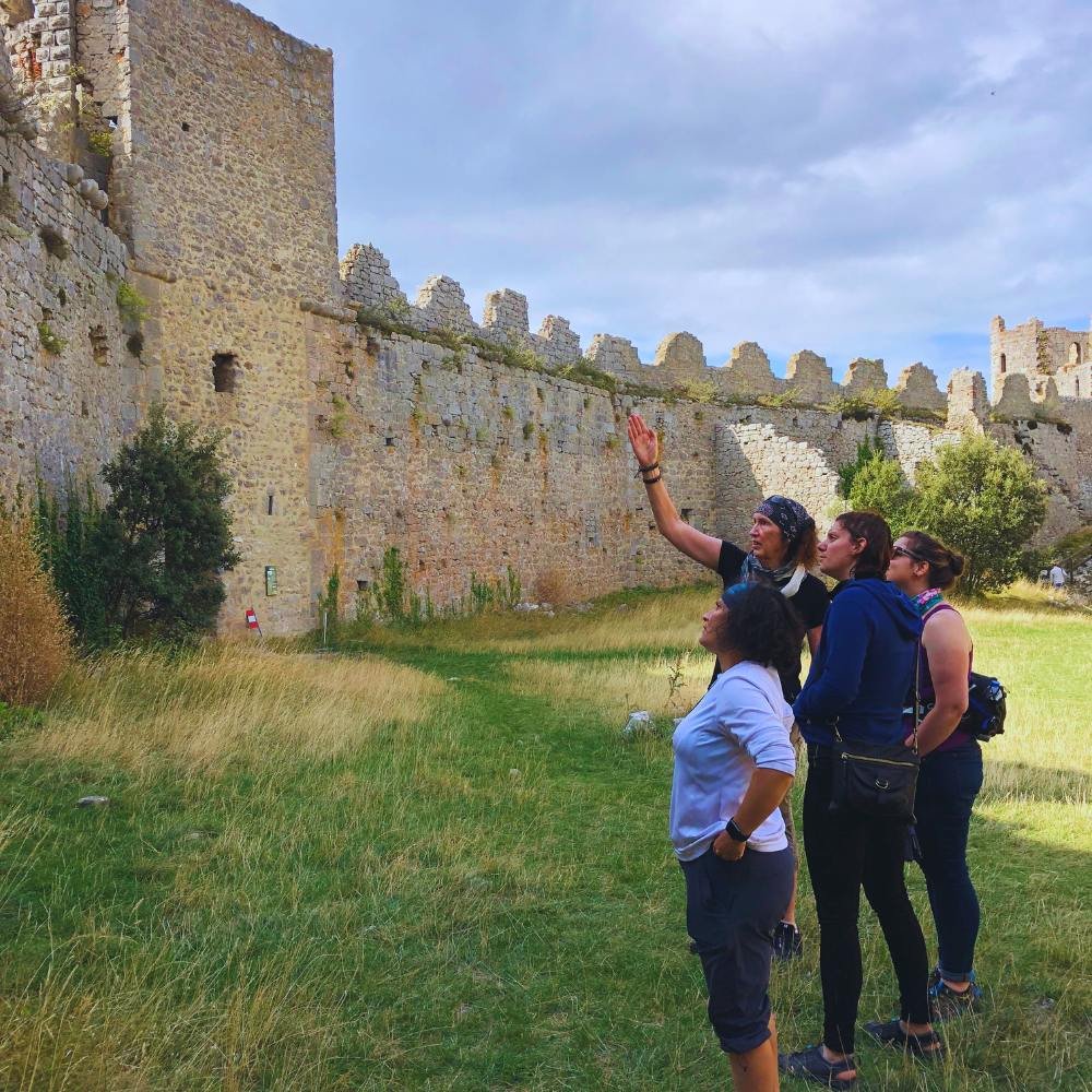 Woman gesturing and teaching others about the castle.