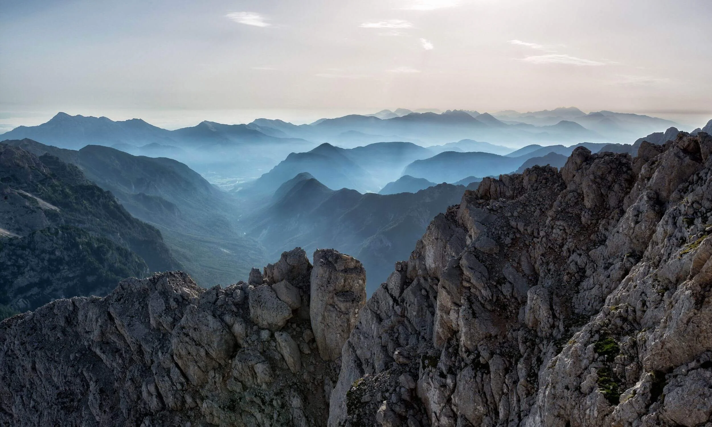 View of rocky Mountains with fog folding over the landscape.