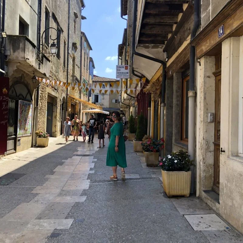 Woman looking over shoulder in Medieval French village