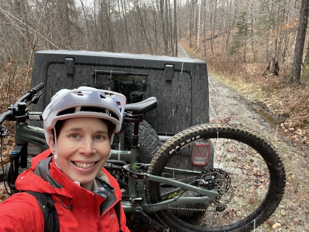 Seoka with her mountain bike on a forest trail in France, leading a women's retreat in europe.