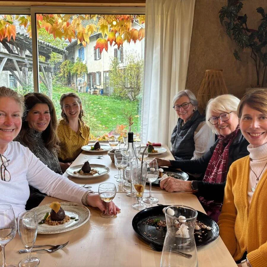 a group of women smiling round a table in France