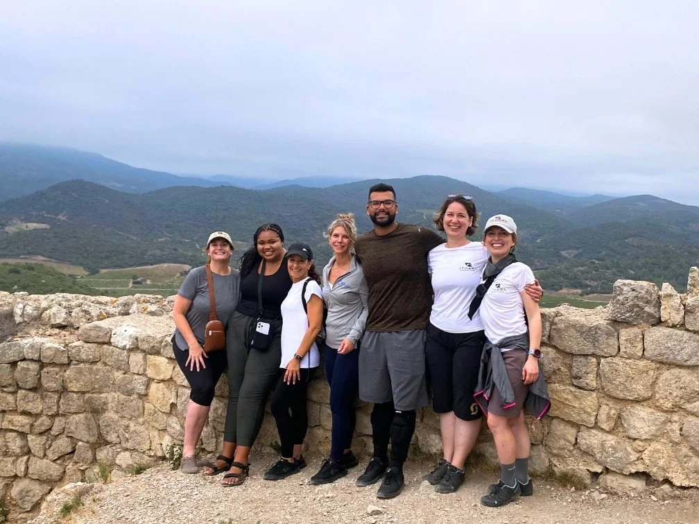 group of people smiling and posing on top of a cathar castle