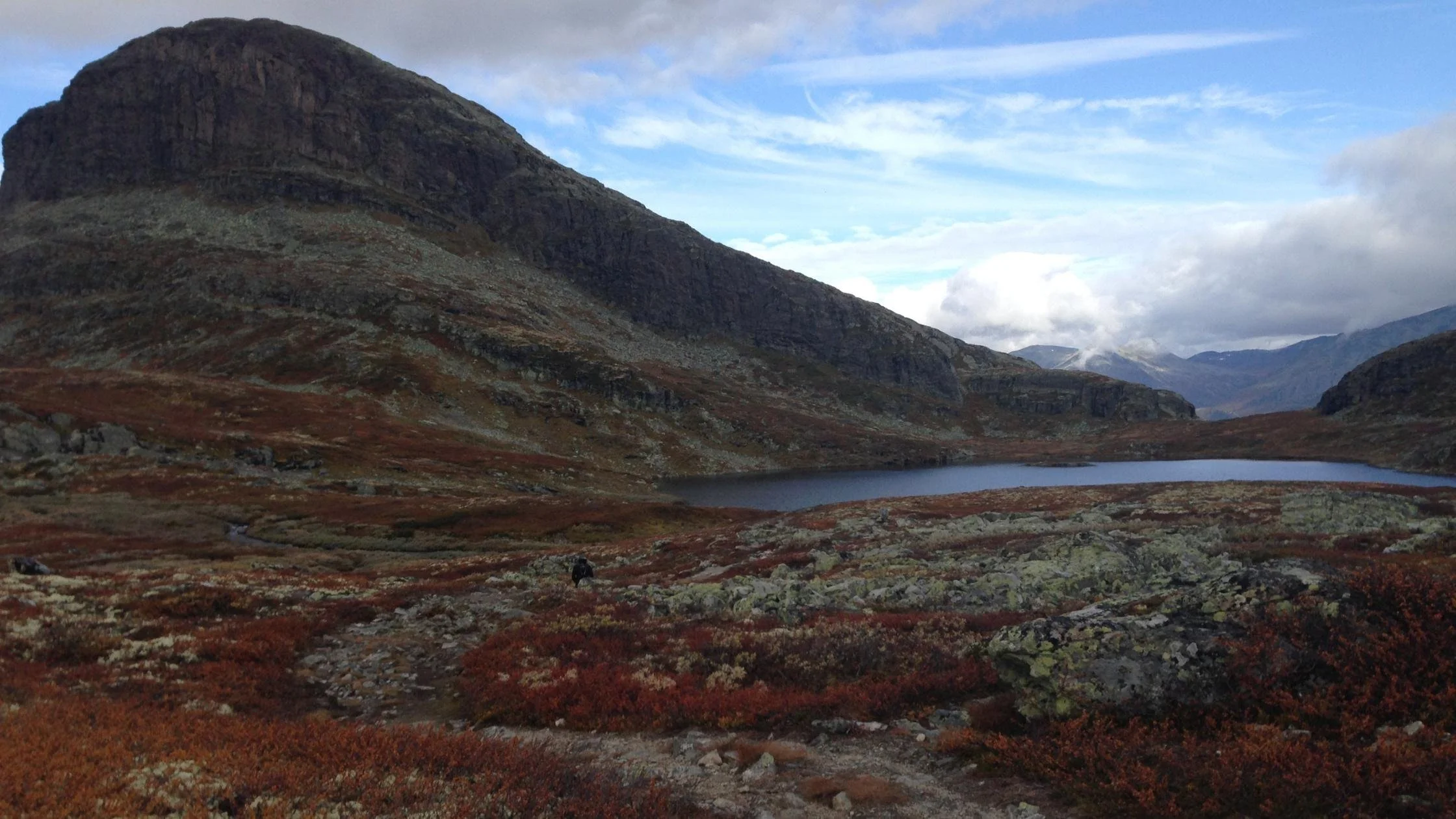 mountain with a small pond in front of it in Norway