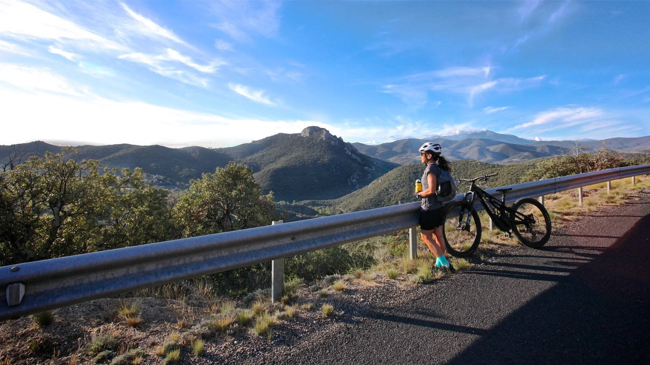 woman taking a break looking out at a mountain scene from Athara trip