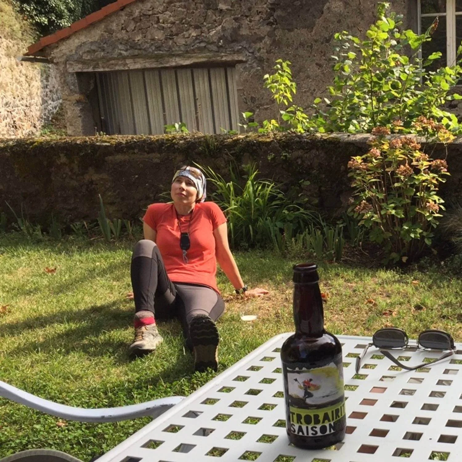 eoka resting on the grass outside a stone building during an Athara retreat in Europe.