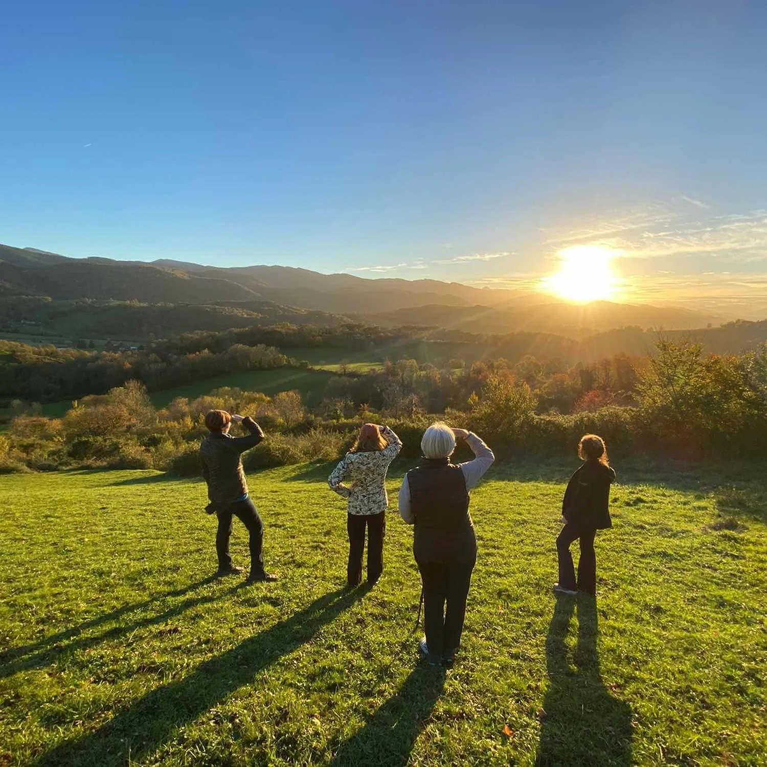 Women's wellness retreat image of women looking out at sunset