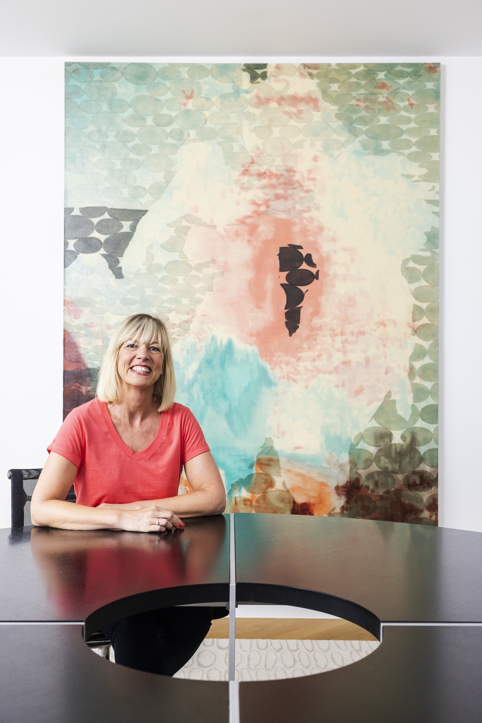 Corporate portrait of a woman at an office table