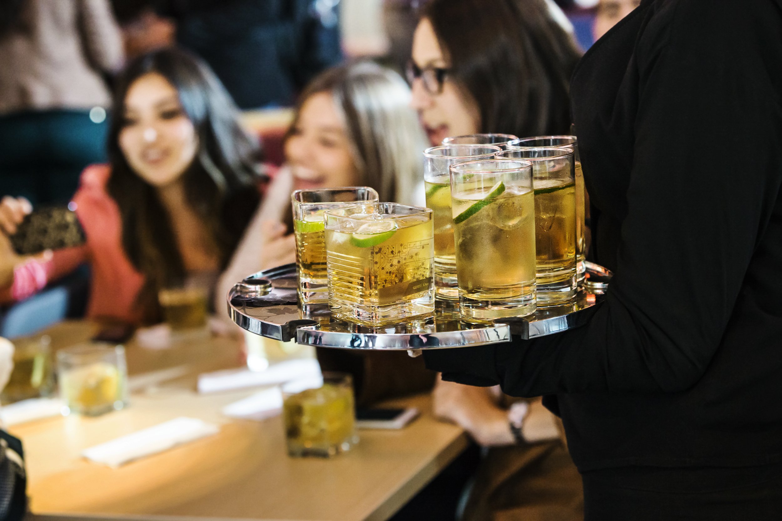A lifestyle photo of a round of drinks being served