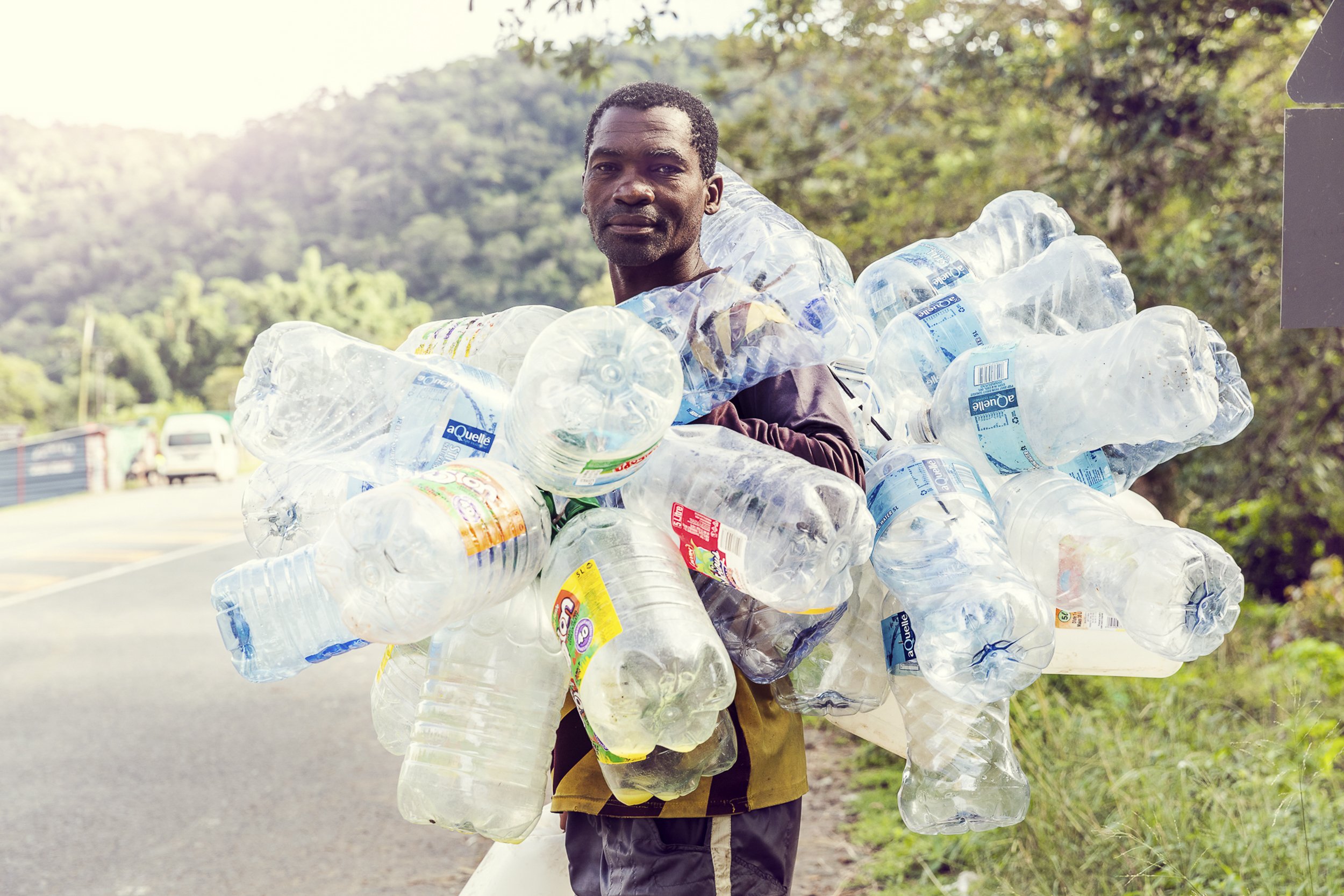 Reportage of man with many plastic bottles