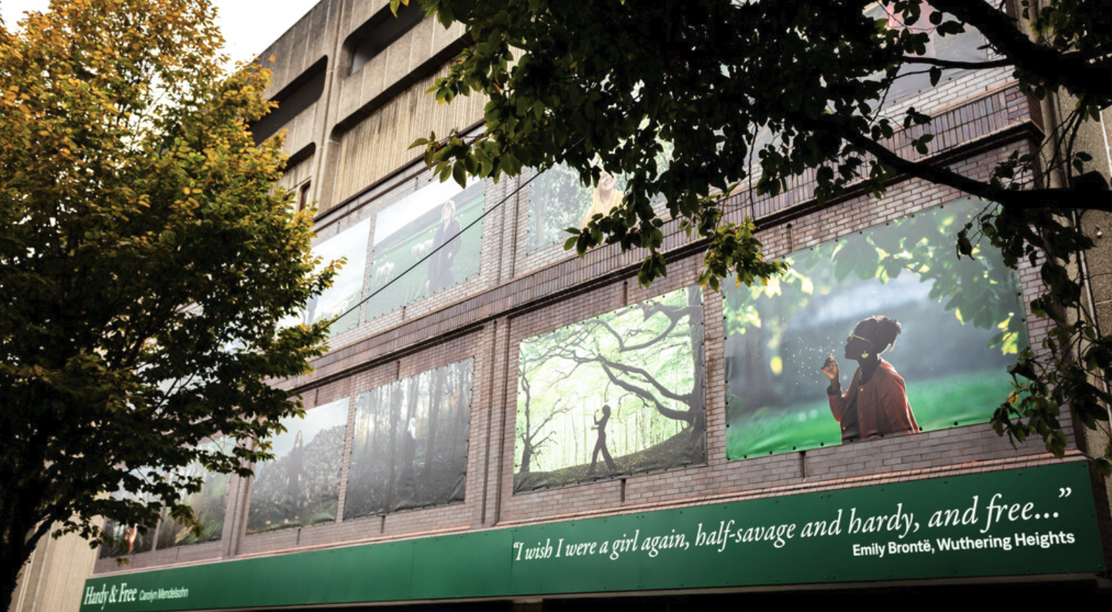 Large-scale photographic installation on building exterior in Bradford city centre, from Carolyn Mendelsohn's expanded 'Hardy and Free' series for Bradford City of Culture 2025