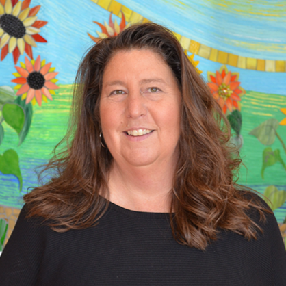 Man wearing glasses, bald head, slight bear, blue shirt, blue suit, gray background