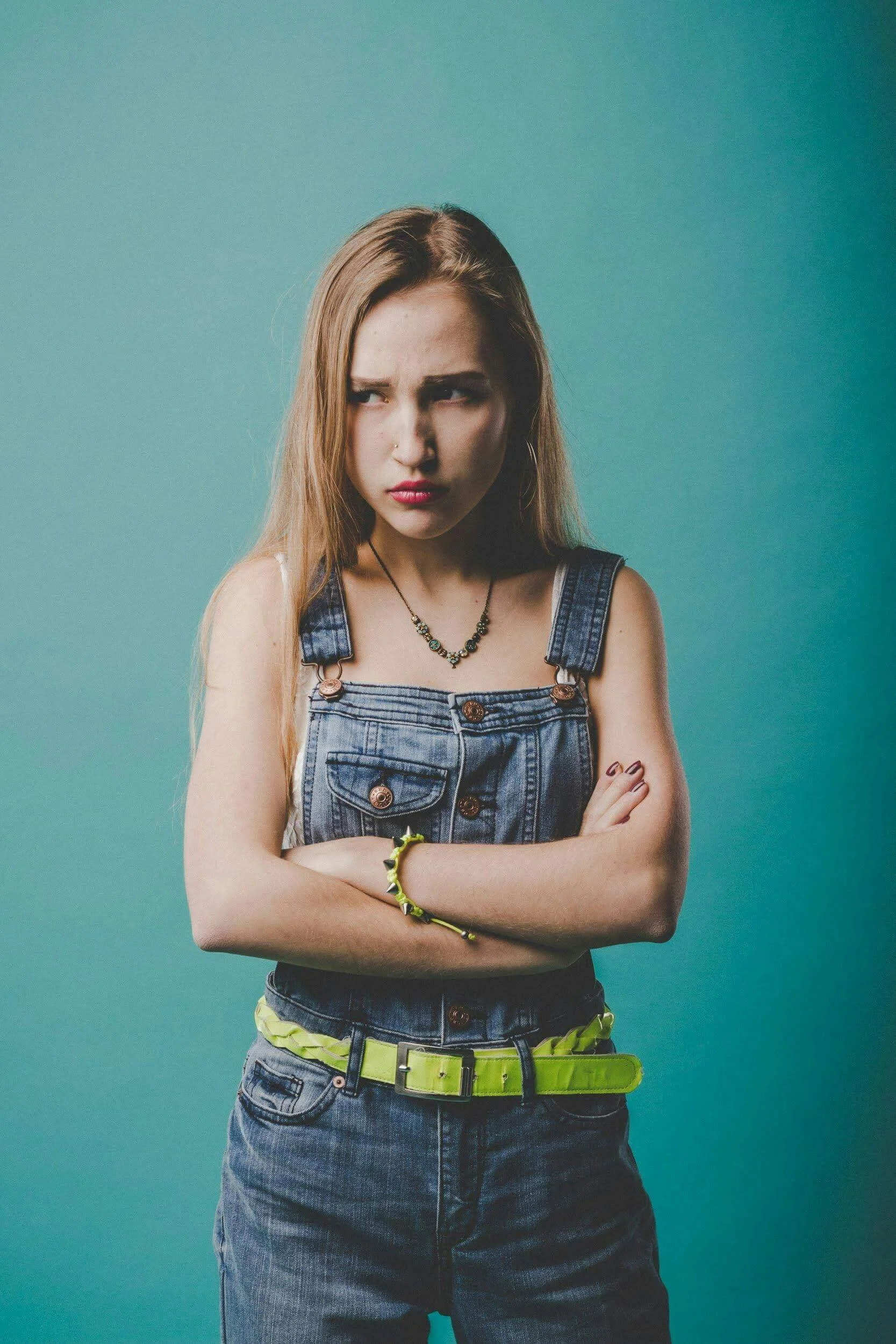 A teenage girl stands with arms crossed, wearing a defensive expression. Is your teen struggling with anger management and you're not sure where to turn? Support is available through teen therapy in San Ramon, CA.