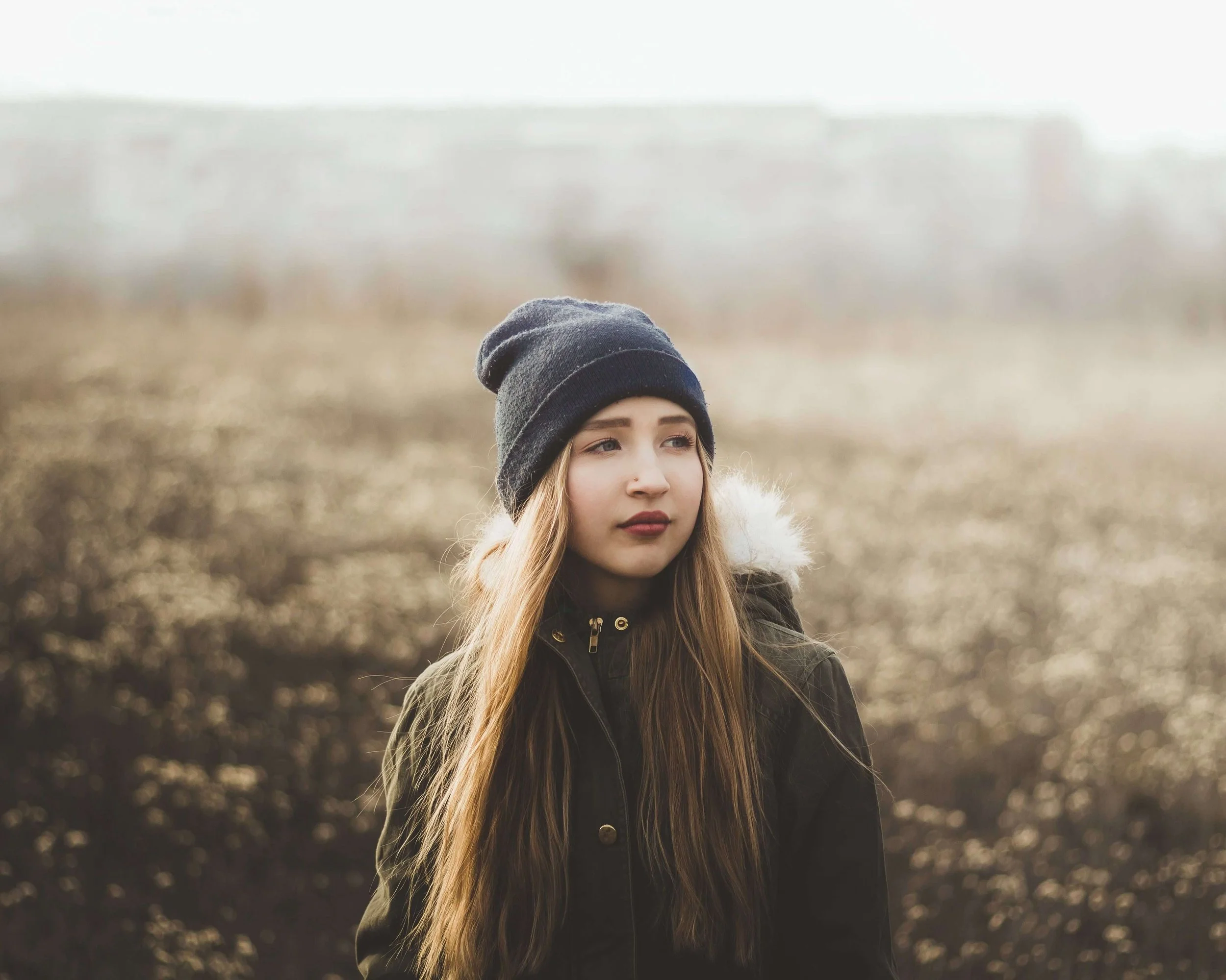 A teen girl in a beanie stands alone in a misty field. Is your teen girl carrying emotional struggles that she doesn't quite have the words to express to the people around her? A teen therapist in San Ramon, CA, can give her a safe space to be heard.