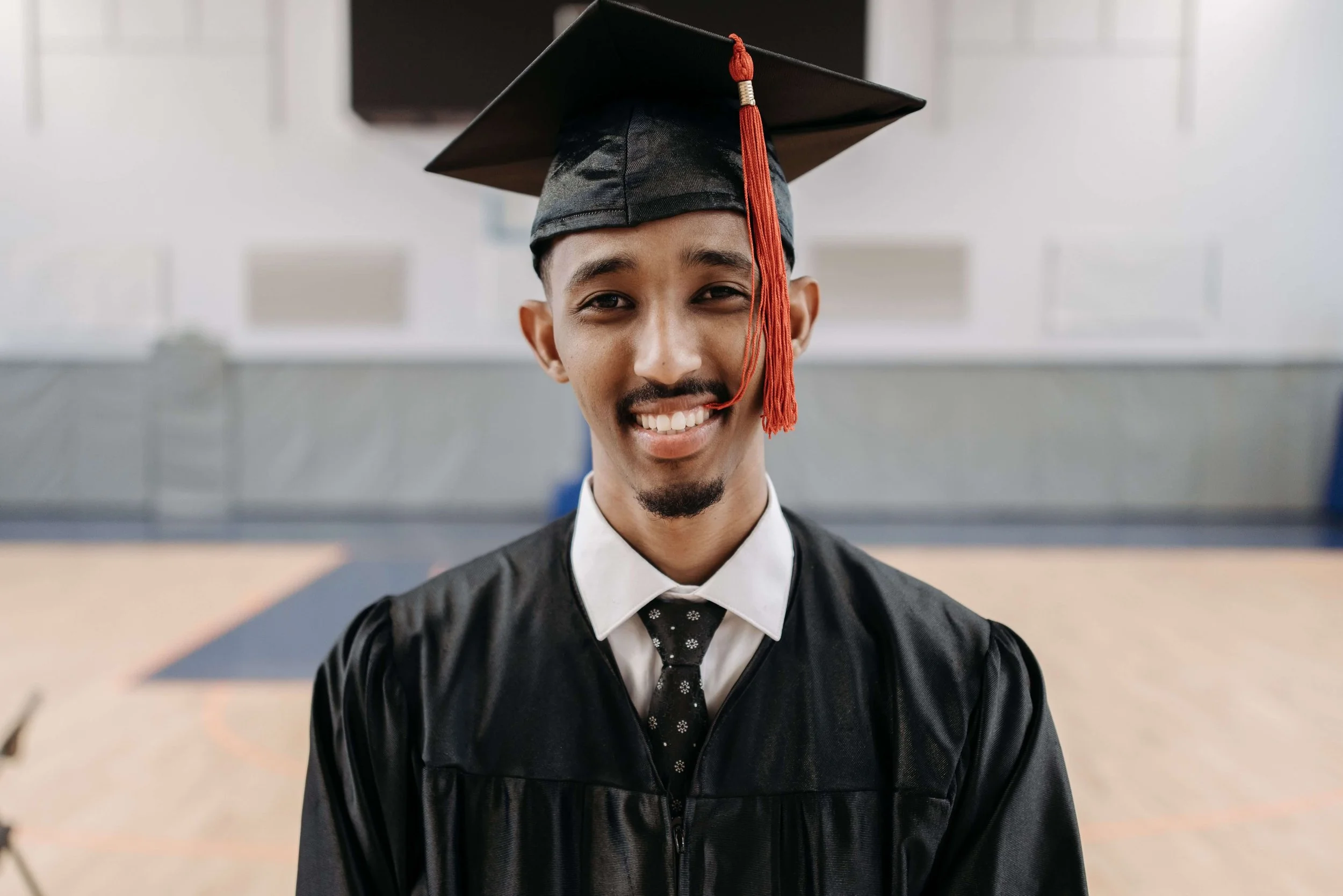 A teen boy smiles proudly while wearing his graduation cap and gown. Are teen achievements starting to feel like your child’s only measure of success? A teen therapist in San Ramon, CA can help your teen find worth beyond accolades.