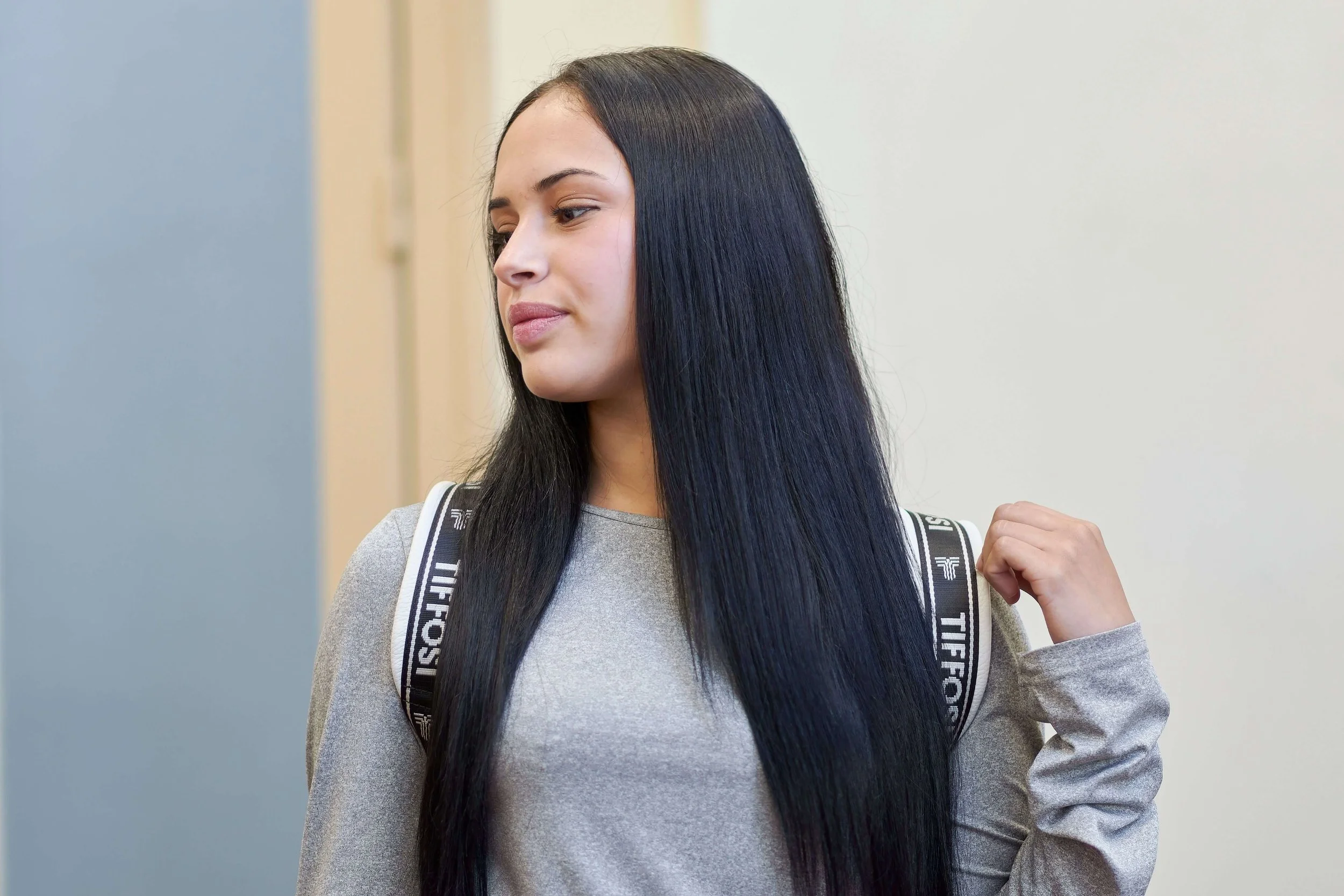 A teen girl glances thoughtfully to the side while wearing her backpack. Does senior year feel like more pressure than celebration for your teen? Teen therapy in San Ramon, CA offers support for the emotions that come with this milestone.