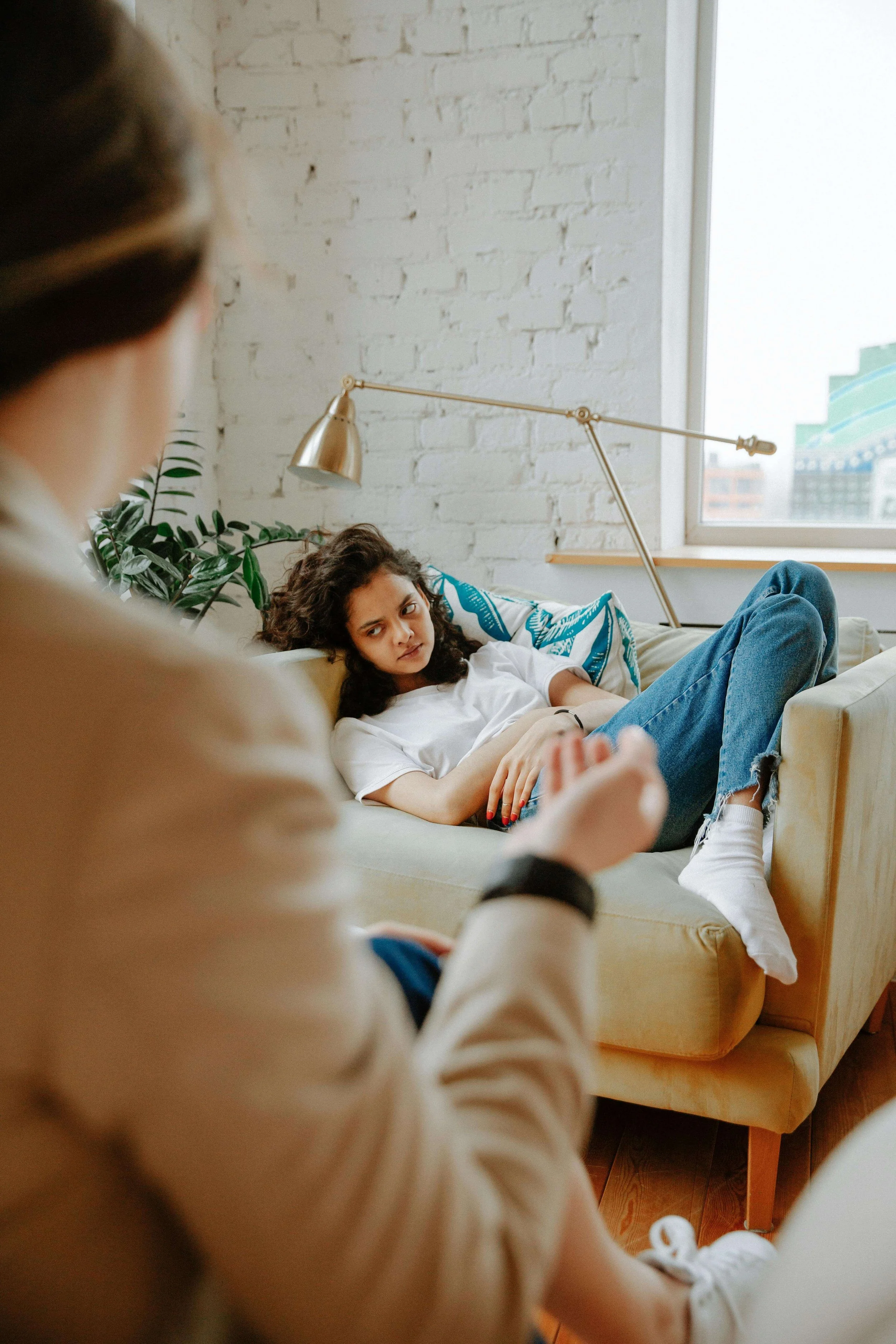 A teenage girl reclines on a couch during a therapy session. Is your teen struggling in ways an educator therapist might uniquely understand? A teen therapist in San Ramon, CA, can connect school life and emotional well-being.