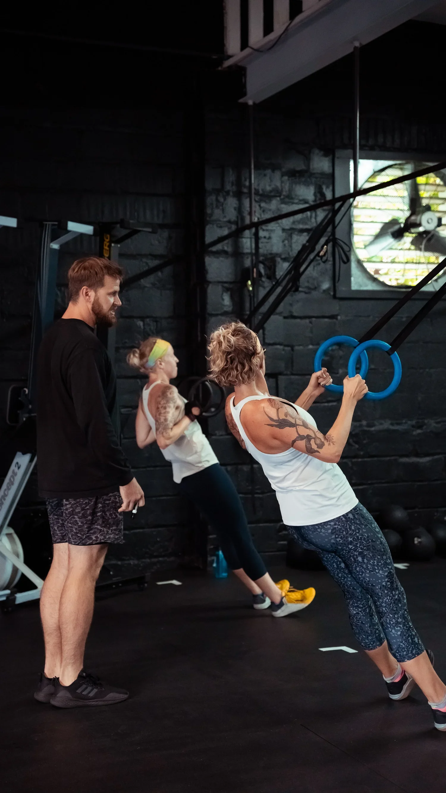 Coach guiding members through ring training at Char Fitness Club in Montclair, NJ