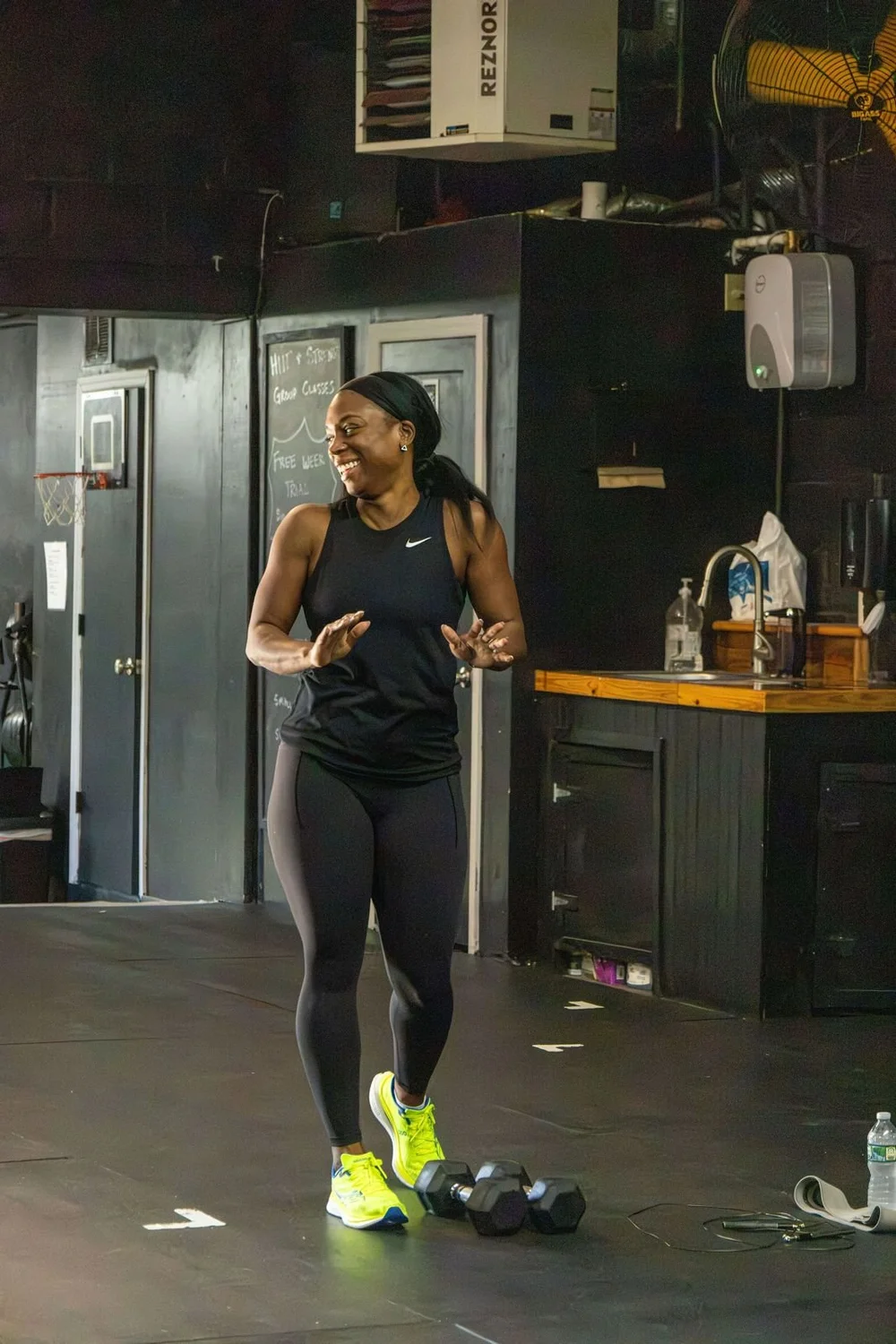Smiling Char Fitness Club coach on the gym floor