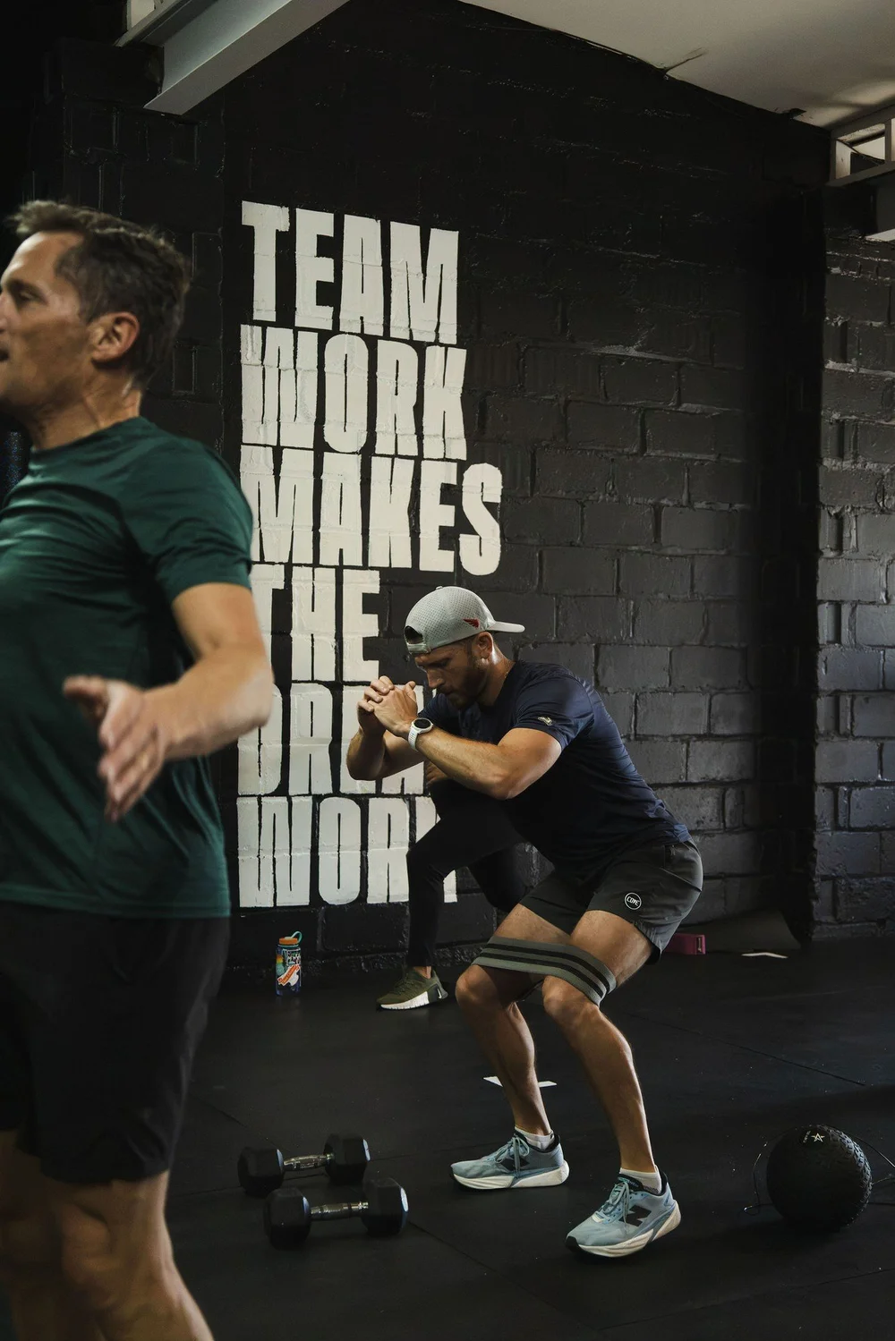 Coach guiding a member through a squat at Char Fitness Club