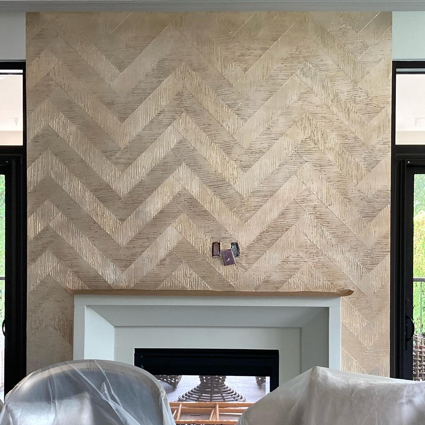 herringbone plaster texture with silver leaf and an oil rub finish.  KDWA &amp; I tag teamed this wall to spotlight the fireplace.
