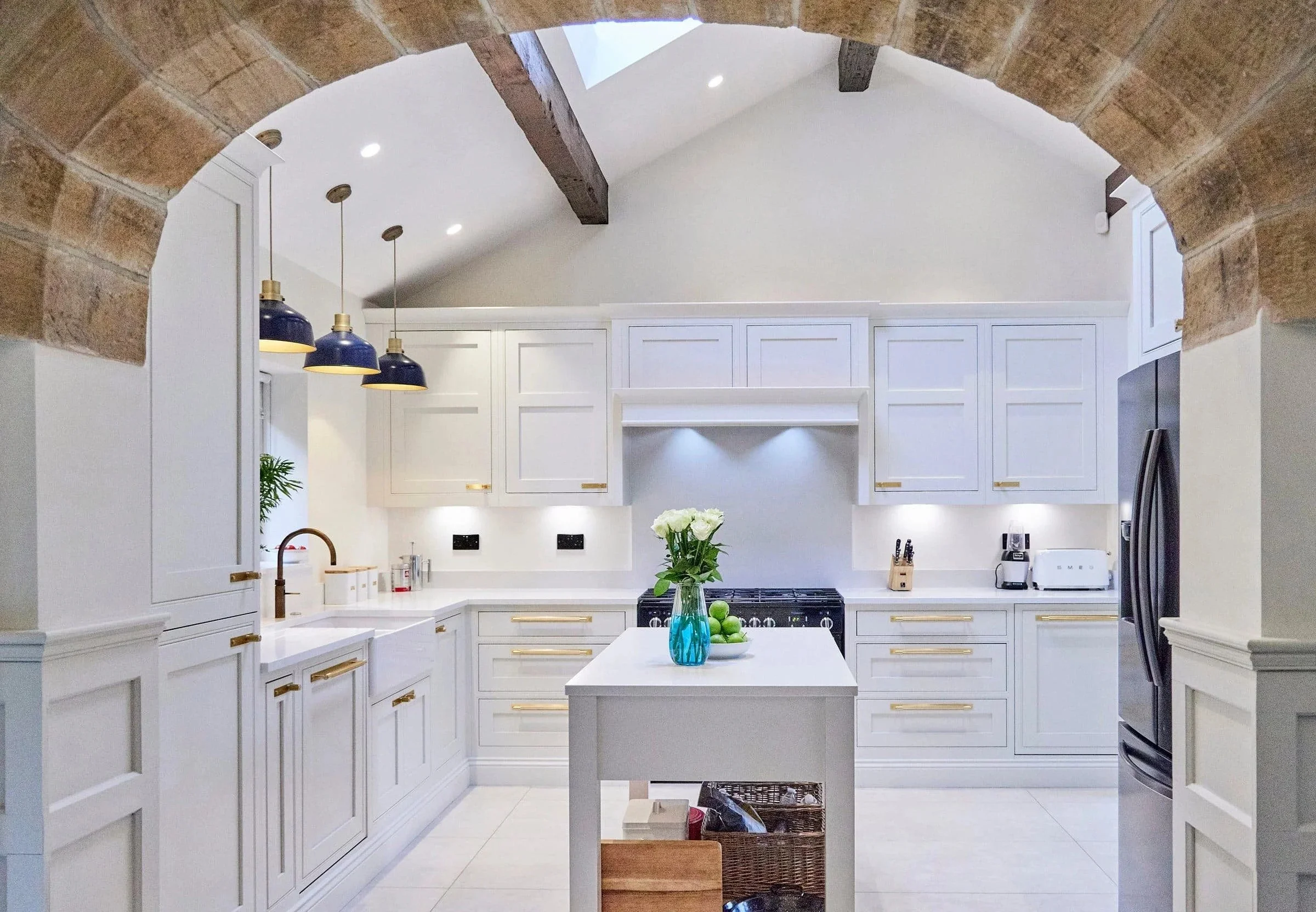 Classic shaker kitchen with vaulted ceiling and central island by Fineline Interiors in Warrington
