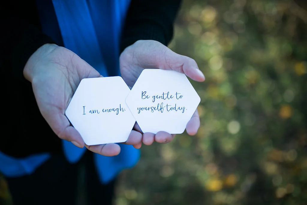 NYC HSP therapist, Maya, holds quote cards. Women in New York City who are highly sensitive or HSP women in NYC can get therapy here! Try online therapy for highly sensitive people in New York too.
