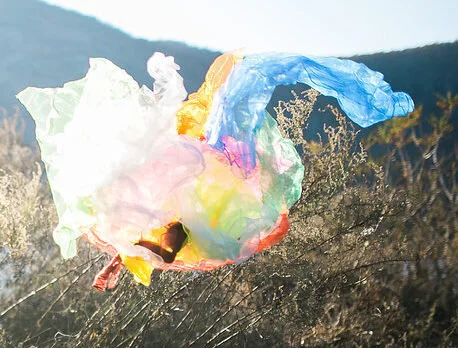 Colorful scarves in the air by the Hudson River in NY, to depict how trauma therapy can help you connect with and express all your feelings vs staying stuck in black and white rigid thinking.
