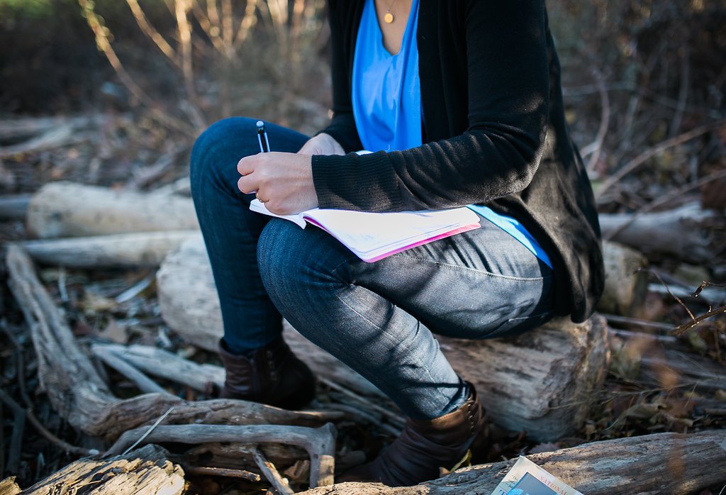 Journaling near the Hudson River, a gentle body check-in exercise for reconnecting with your body.