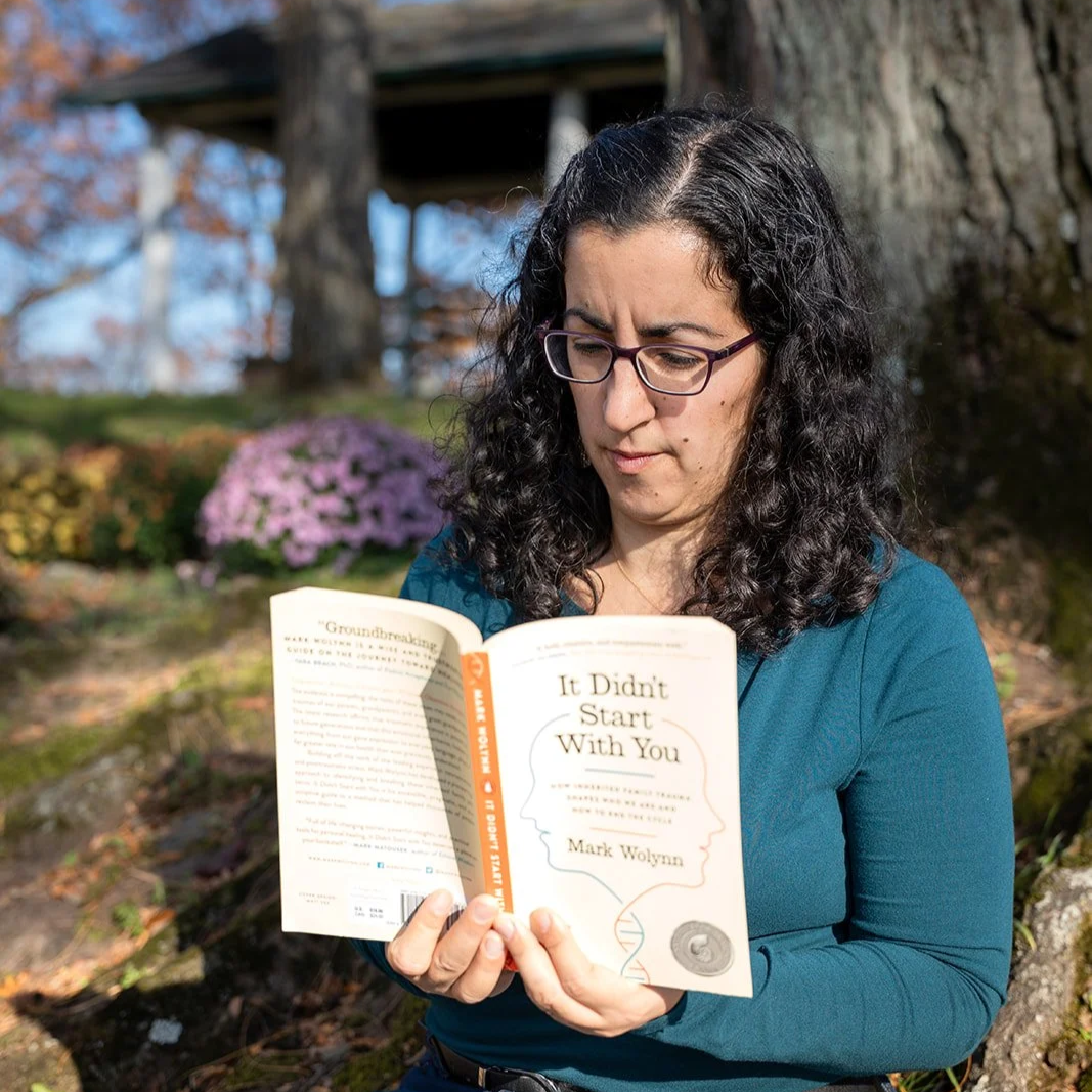 Trauma therapist reads intergenerational trauma book in Hudson Valley NY.