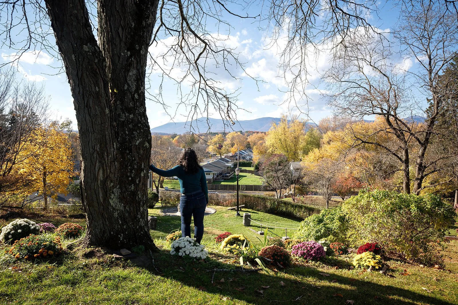 Woman standing outdoors in warm sunlight, reconnecting with her body after childhood trauma.