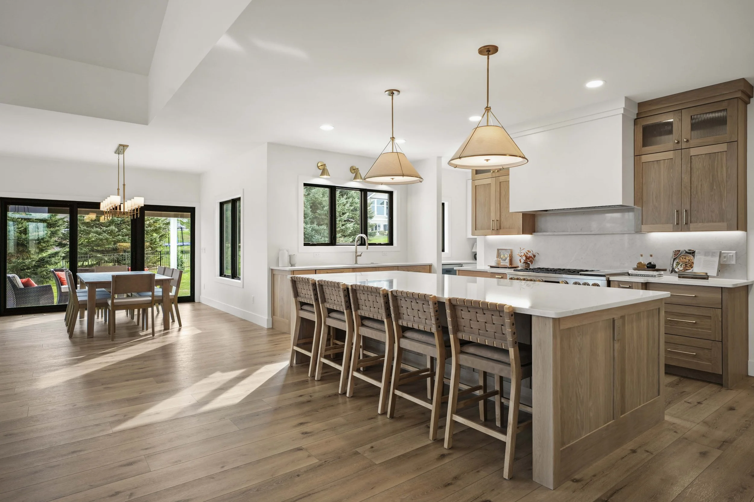 urso-builders-2025-parade-of-homes-gallery-kitchen-with-breakfast-bar-and-open-dining-room.jpg