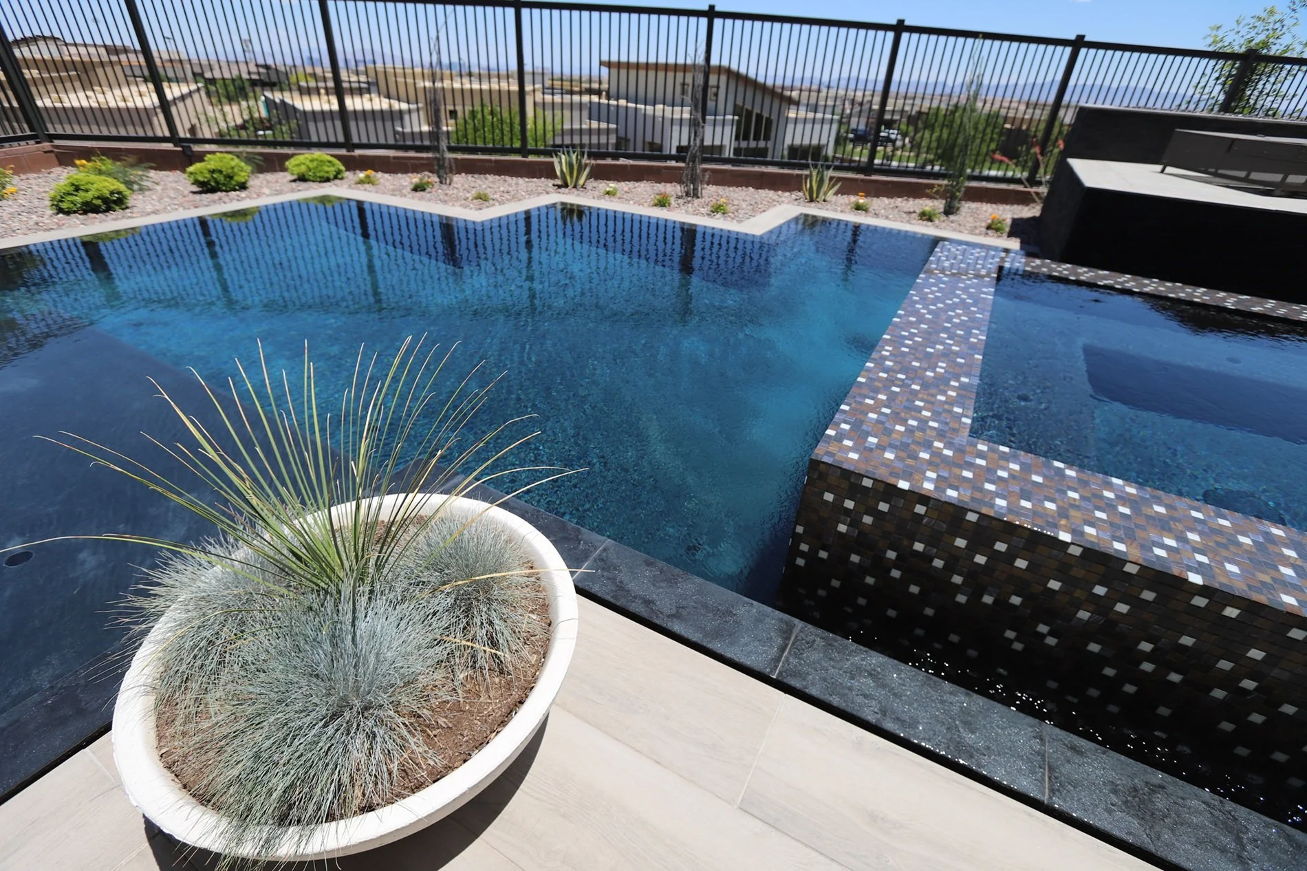 Perimeter overflow pool with a raised spa