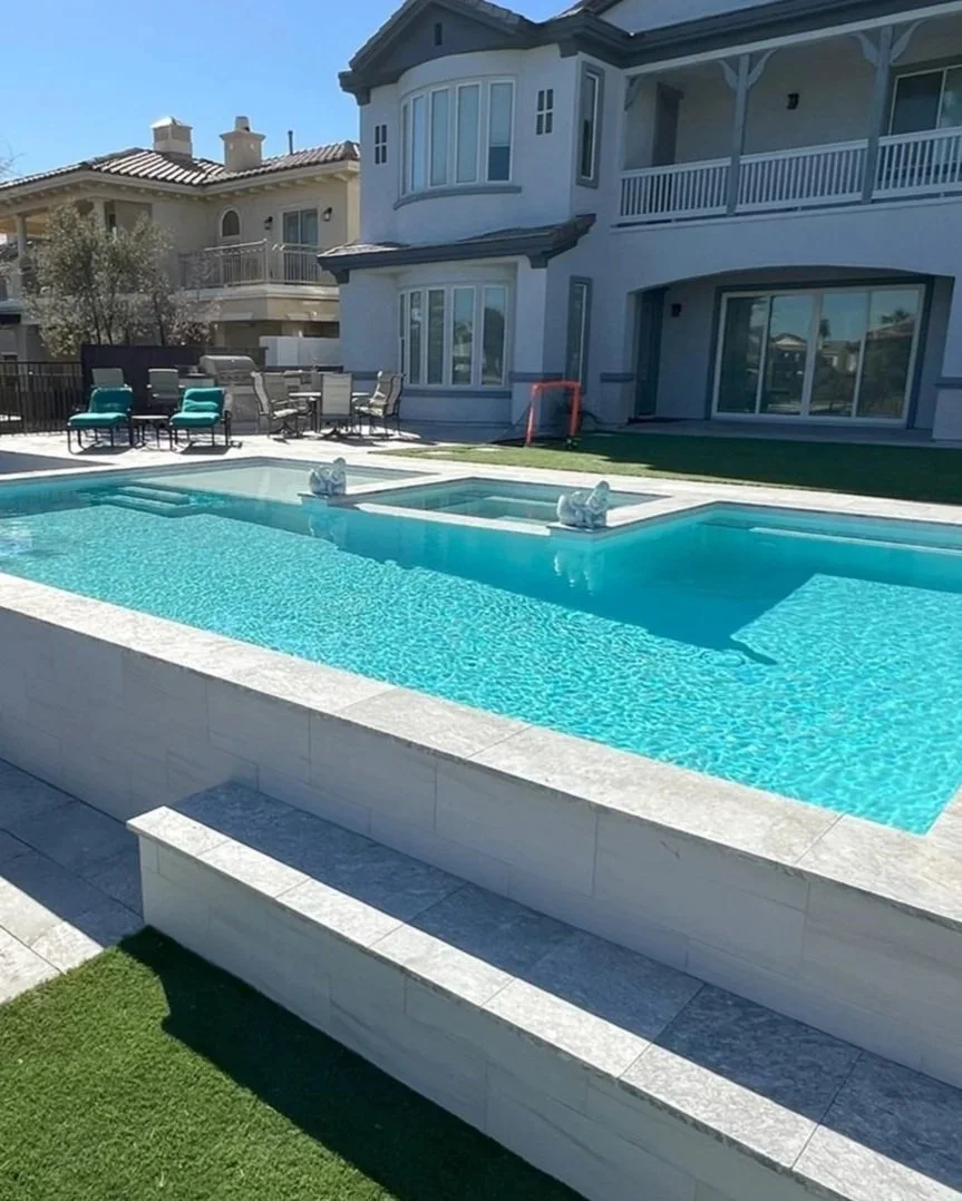 A pool remodel by Paragon Pools, the old pool was removed and a new custom swimming pool and spa was constructed.