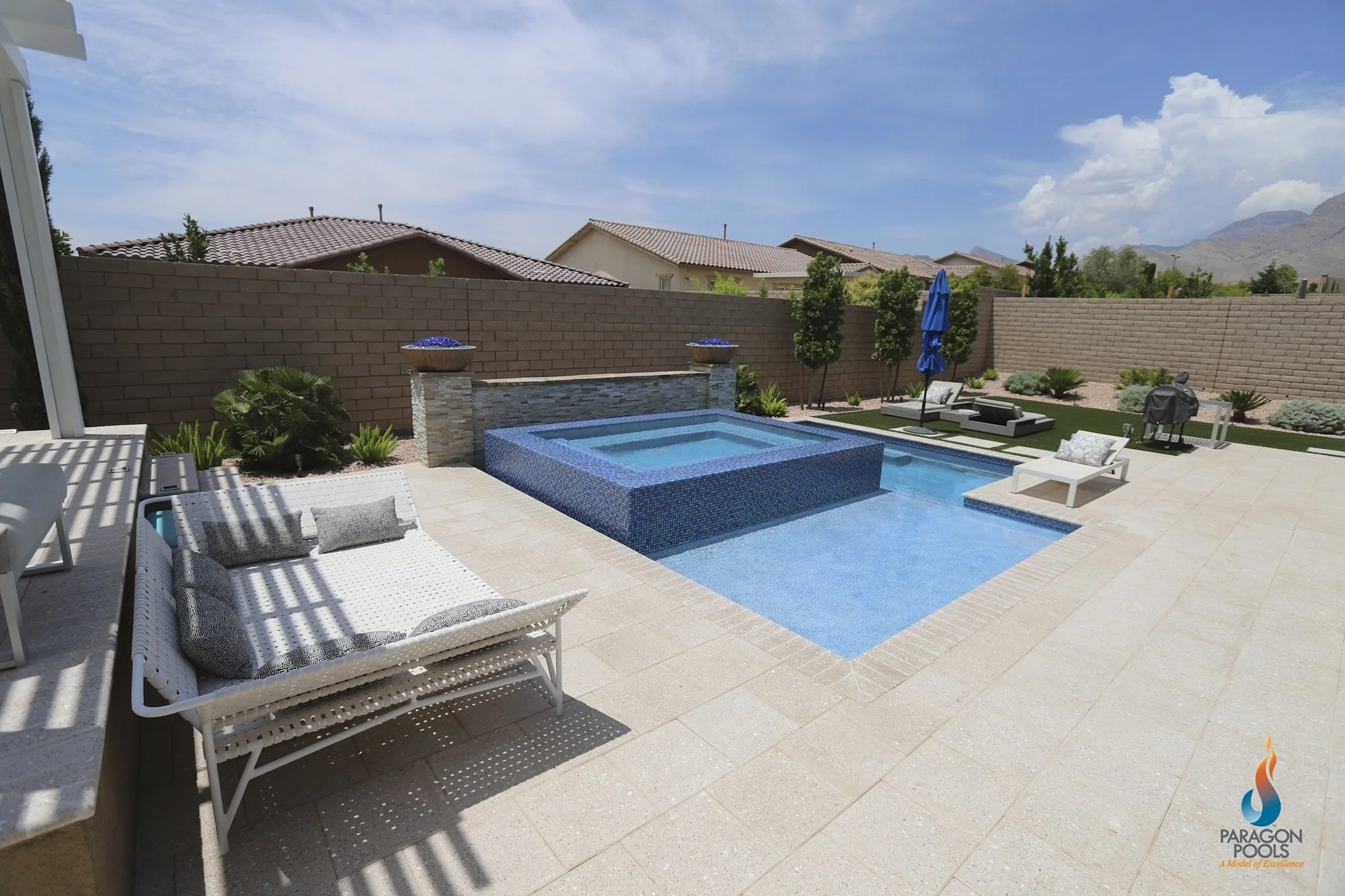 A beautiful backyard with a custom raised perimeter overflow spa, a large tanning ledge and a side plunge pool.