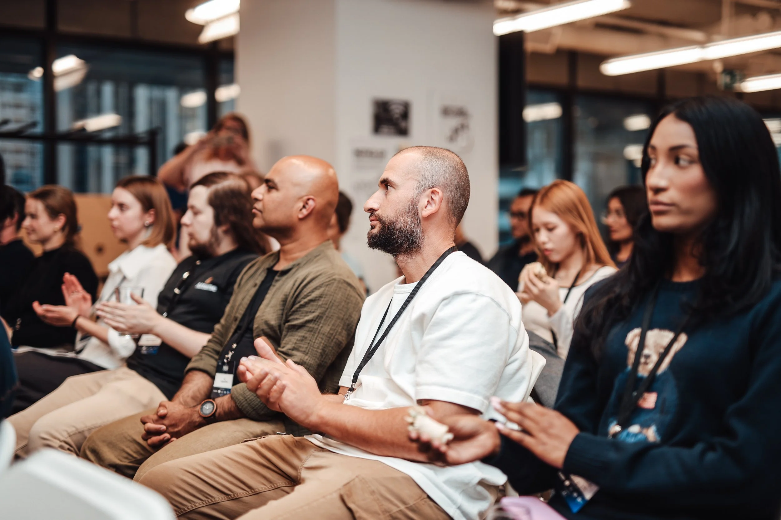 People sitting in audience at conference or seminar, attentive and engaged.