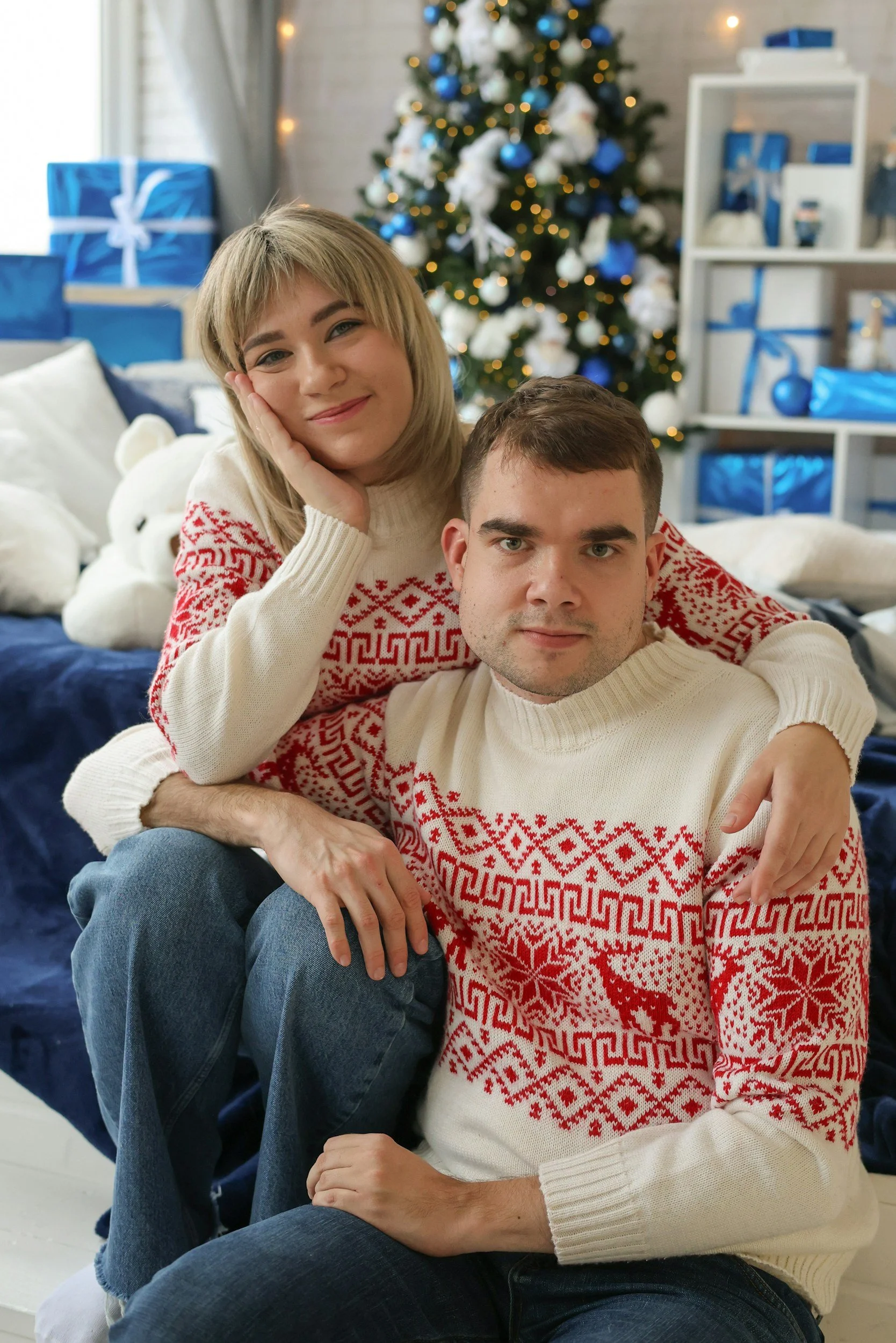 two people wearing matching holiday sweaters couples therapy michigan