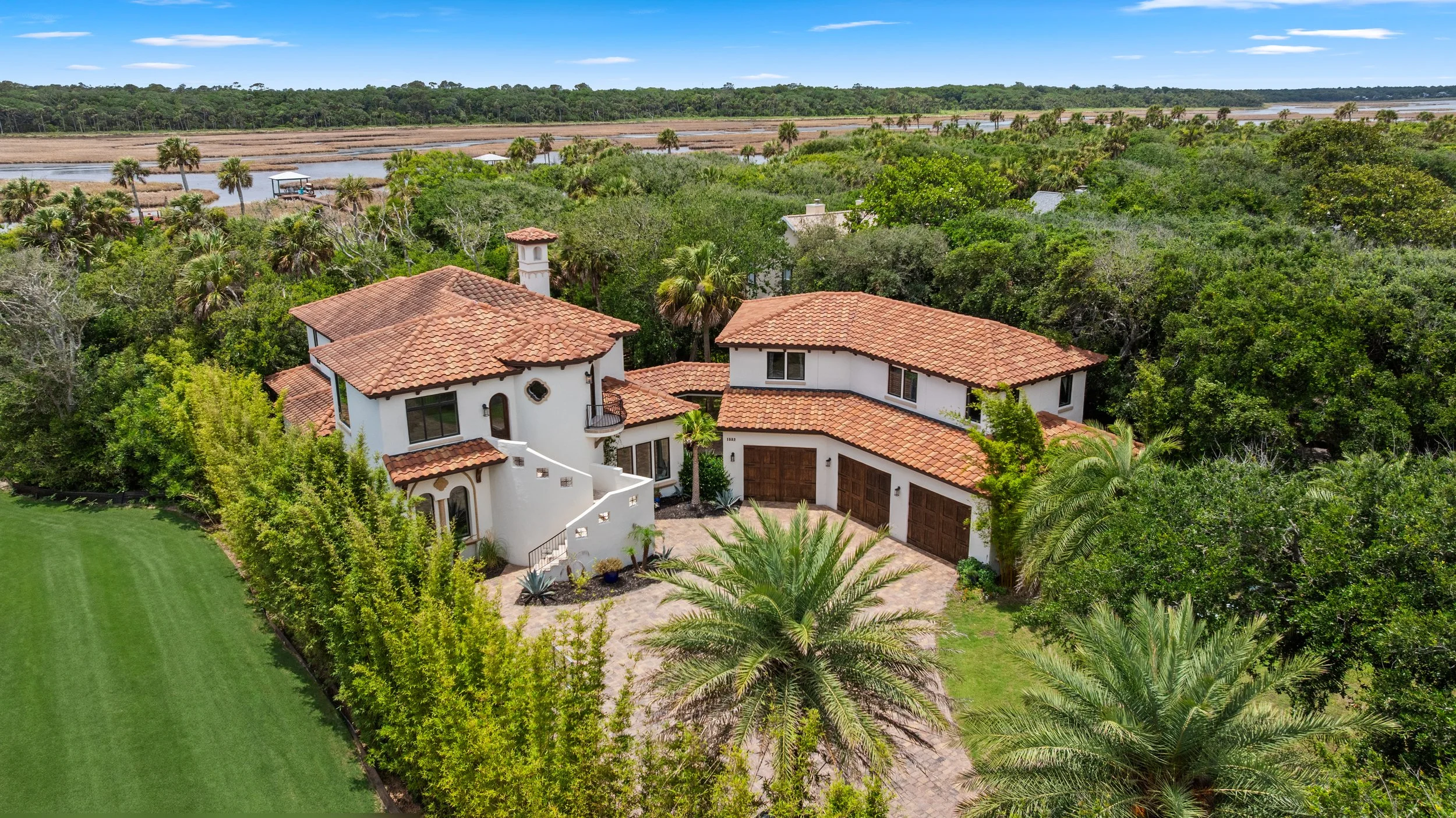Aerial view of a Spanish-tile-roofed estate with a courtyard entry, surrounded by manicured landscaping in Ponte Vedra, FL.