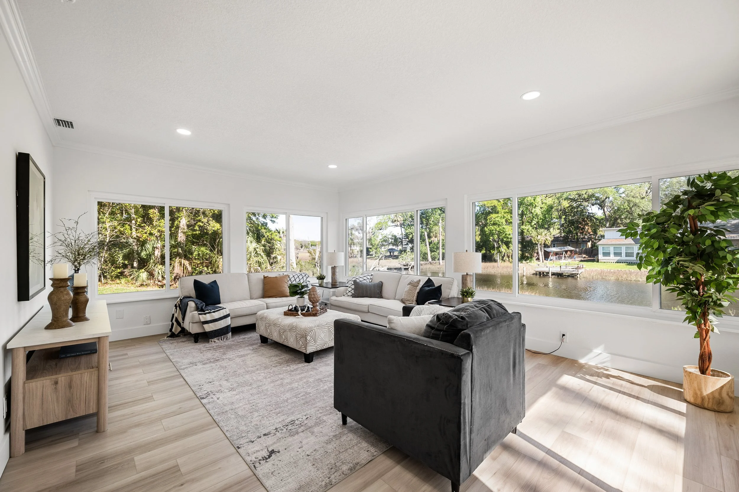Bright, modern living room with a tray ceiling and sectional sofa, Jacksonville, FL.