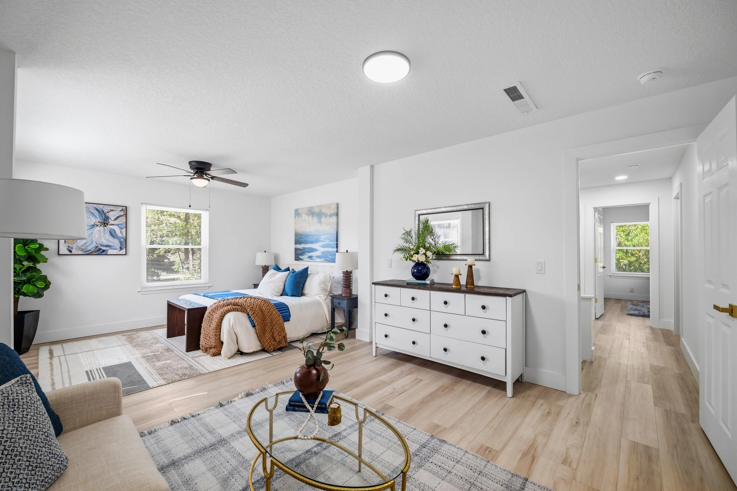 Bedroom with a dresser and doorway leading to the hallway.