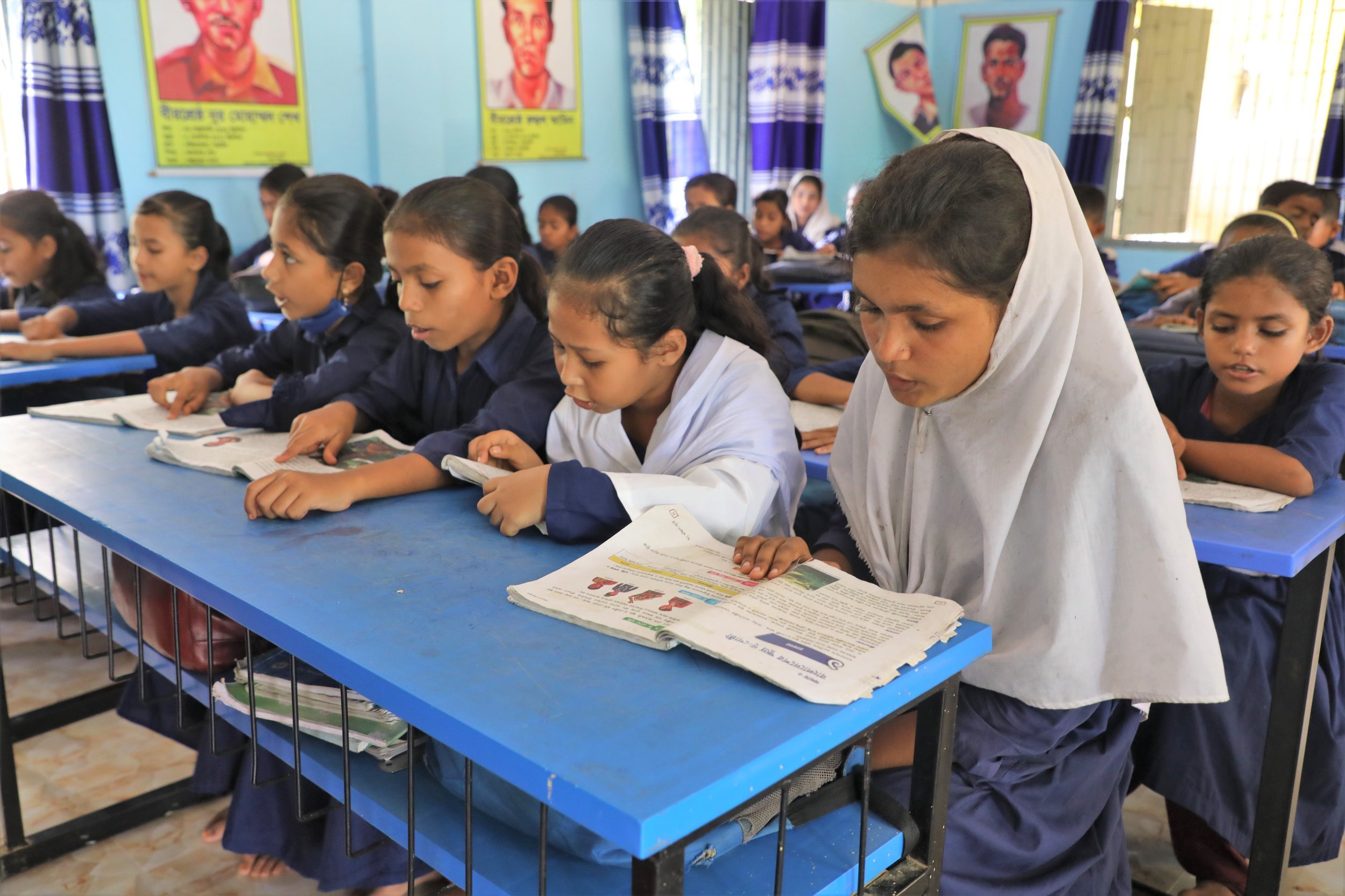  Above: Rifa reading a book in the classroom. She has returned to school after improving her confidence and communications skills in the adolescents club. Photo: Md. Qazi Shamim Hasan, World Vision Bangladesh 