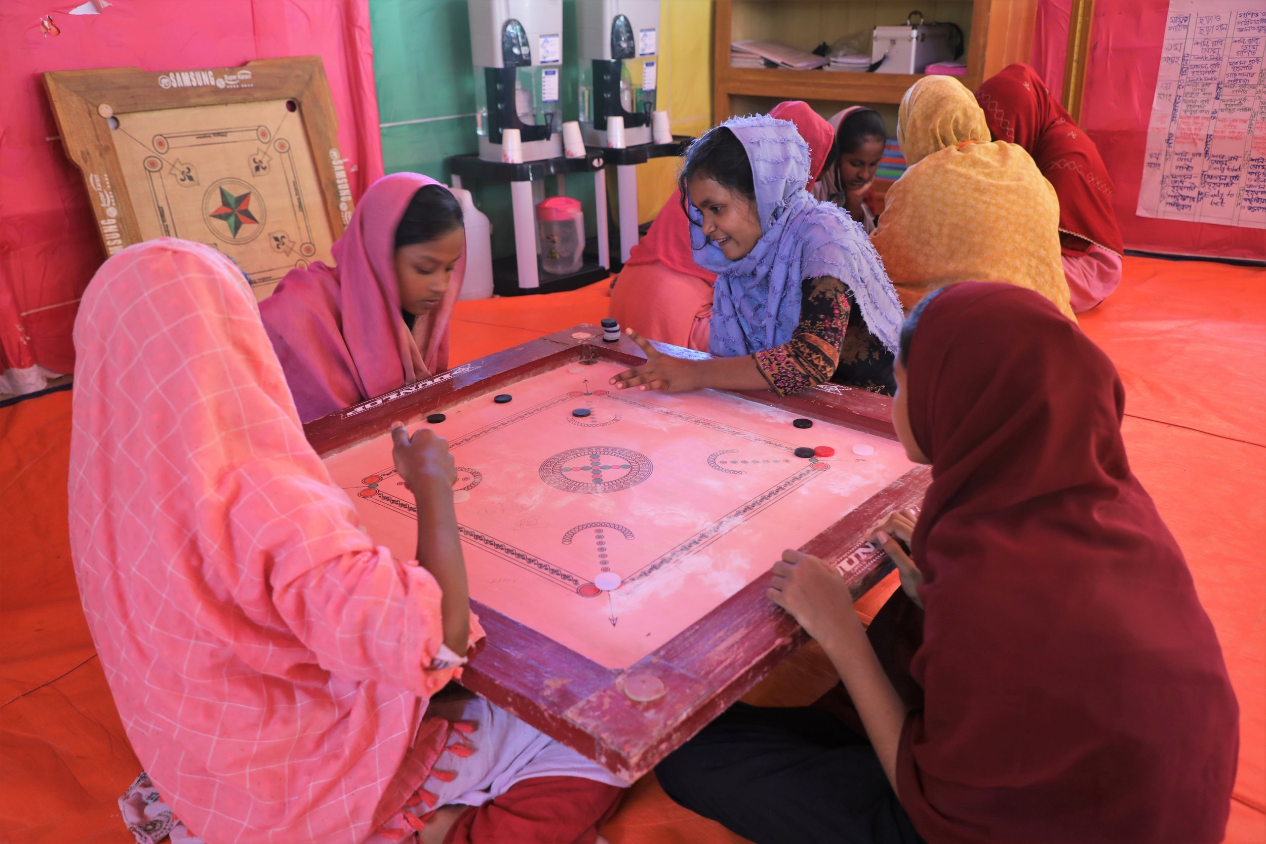 Above: Rifa playing carom with her friends at the World Vision adolescent club. Photo: Md. Qazi Shamim Hasan, World Vision Bangladesh 