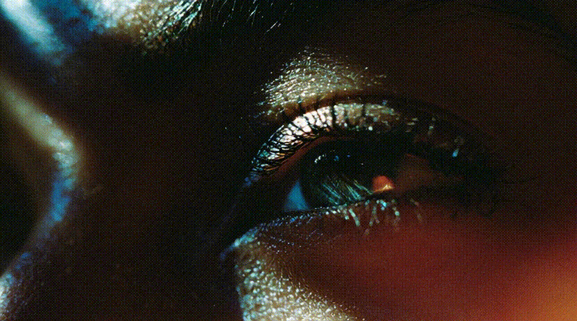 A motion clip of a green eye blinking that was generated as a still in Midjourney, and then animated.