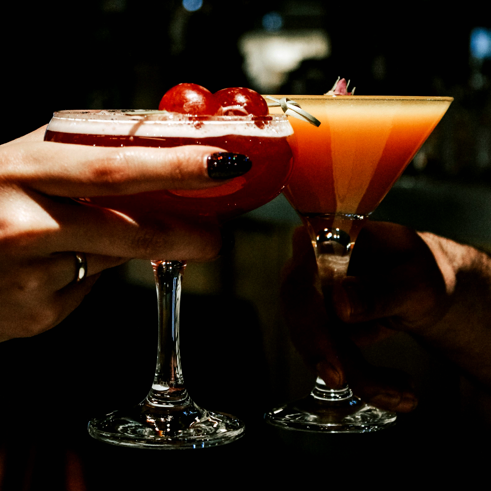 Cocktails being shared in the sun from The Metropolitans Rooftop floor