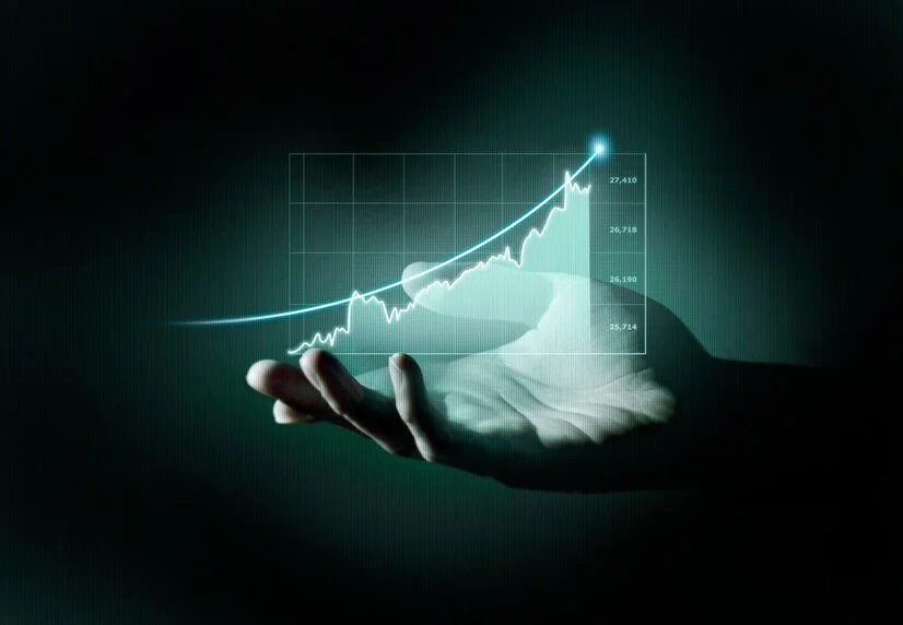 Hand holding a digital graph with increasing trend