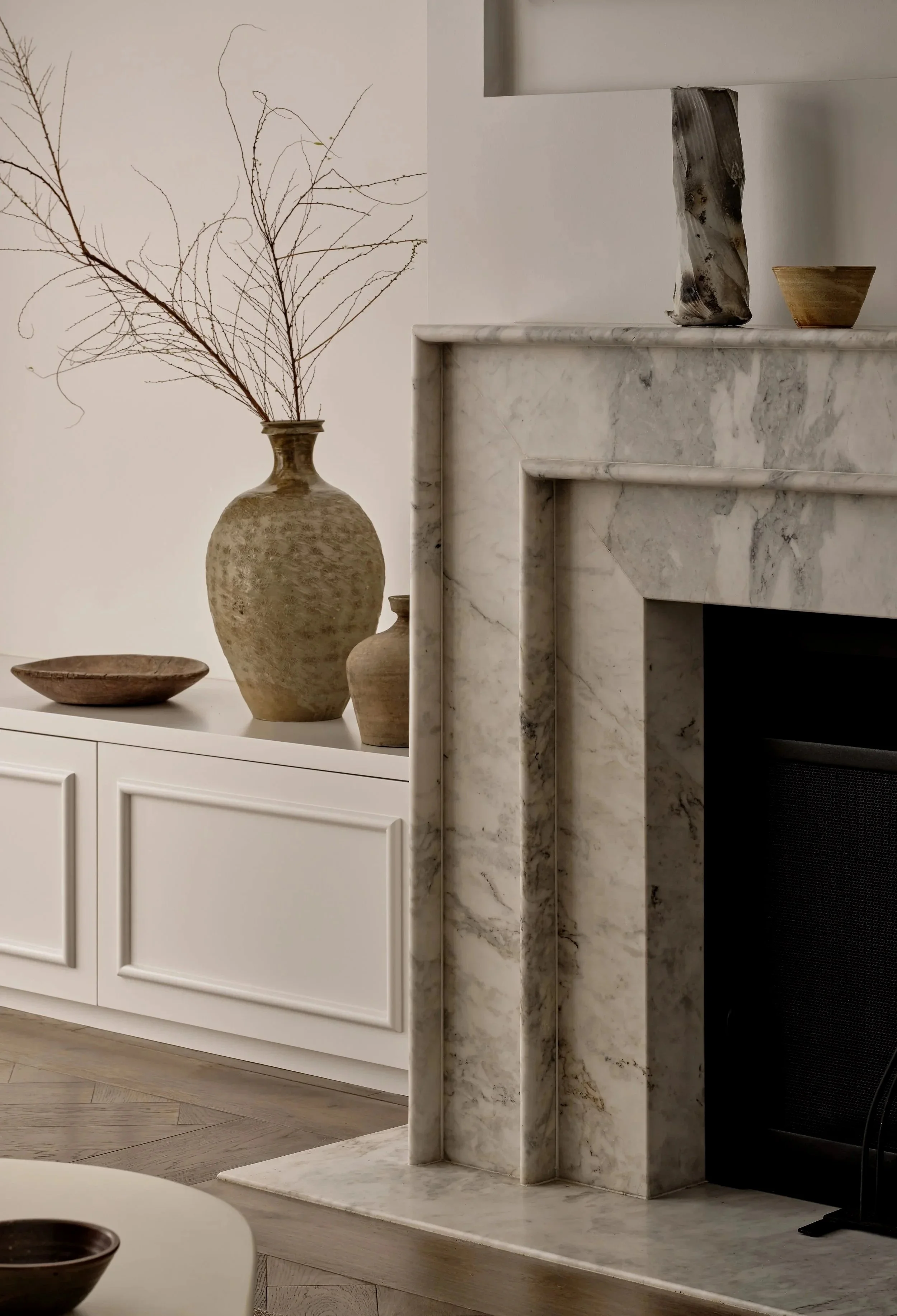 Custom marble fireplace with hand crafted ceramics and antique items