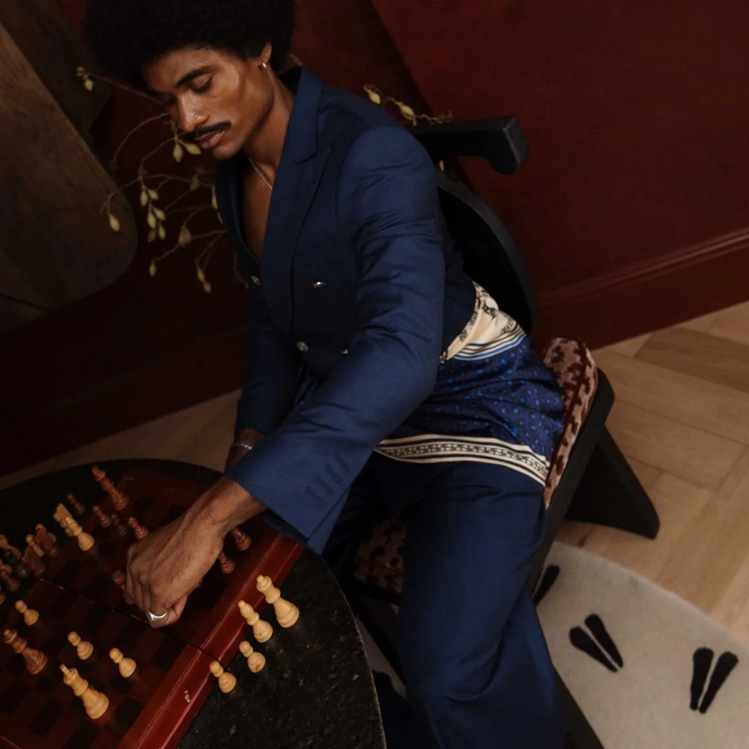 Guest at the MOUNT NELSON X THEBE MAGUGU SUITE LAUNCH, wearing a navy suit